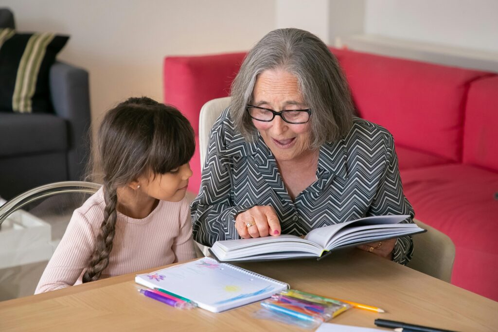 Kid and Grandmother enjoys reading personalised story book